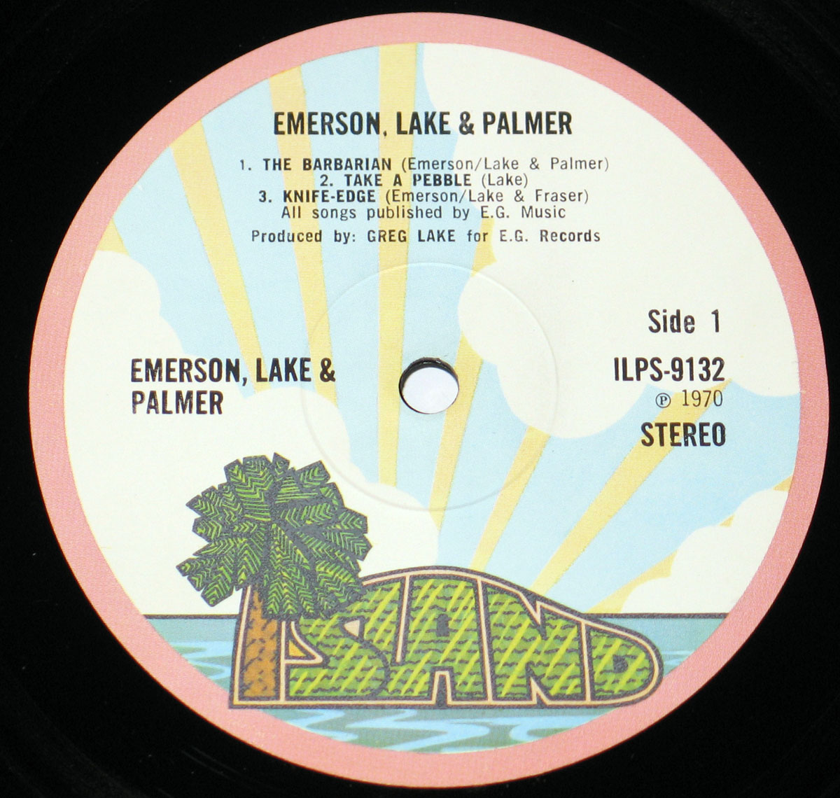 Island Records label for Side 1 of Emerson, Lake & Palmer’s debut album, featuring a tropical island design with palm trees, blue waves, and track details for songs like “The Barbarian” and “Take a Pebble.”